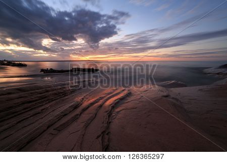 Sunset at Miners Beach in the Upper Peninsula of Michigan. Miners Beach is part of Pictured Rocks National Lakeshore near Munising Michigan