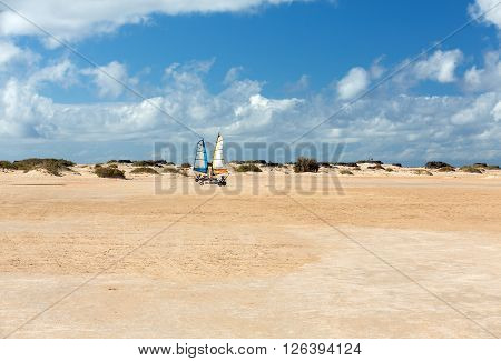 Corralejo Fuerteventura Spain - Spetember 15 2015: People Driving Sand Yachting On The Beach. They A
