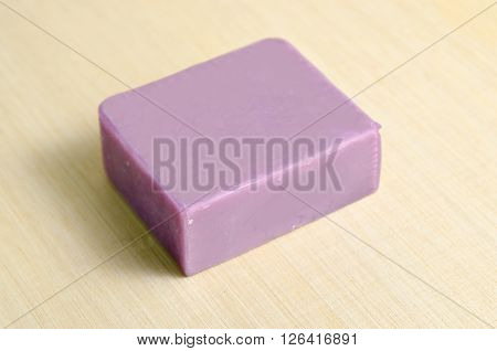 Lavender natural extract soap bar isolated on wooden board background