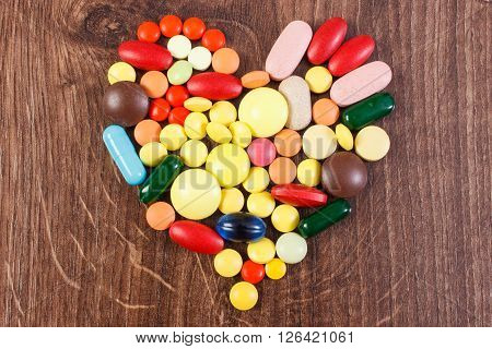 Heart shaped colorful medical pills capsules or supplements for therapy concept of treatment and health care