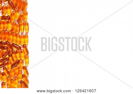 Heap of orange medical pills capsules or supplements for therapy concept of treatment and health care copy space for text or inscription