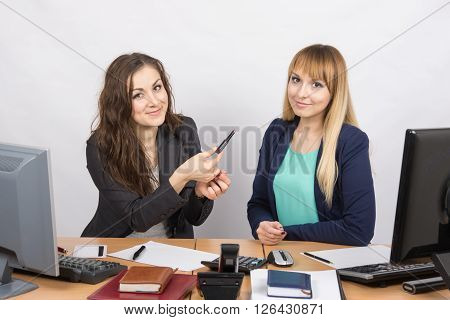 Office Girl Sitting Next To A Colleague Offers Lipstick