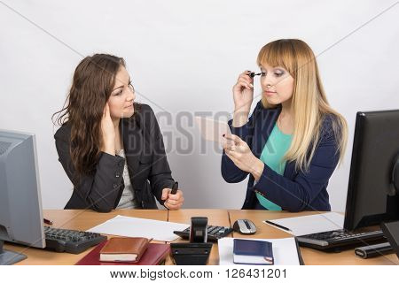 Office Worker Watches As A Colleague Paints Eyelashes At Your Desk