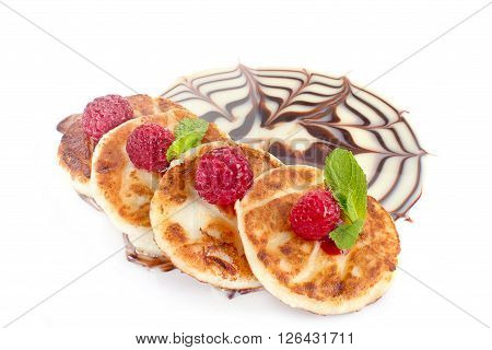 Cheesecakes, curd with raspberries, mint, chocolate and condensed milk isolated sauce