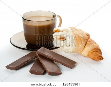 A cup of coffee cornetto and a four pieces of chocolate
