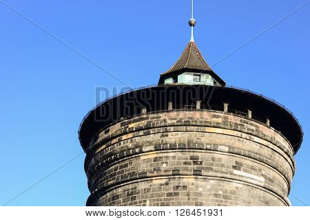 Old historical brick blocks tower with clear blue sky in winter; Nuremburg Germany