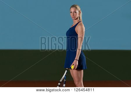 Woman In Sportswear Serves Tennis Ball