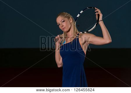 Woman Keeps Tennis Racket On Shoulders