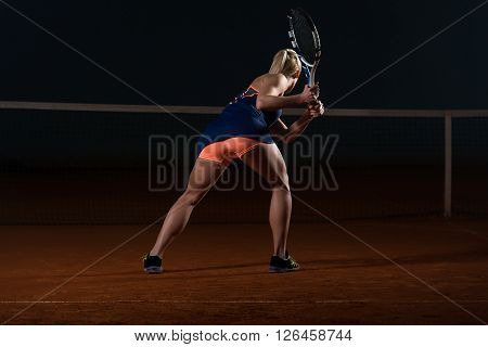 Tennis Player Hitting The Ball On Tennis Court