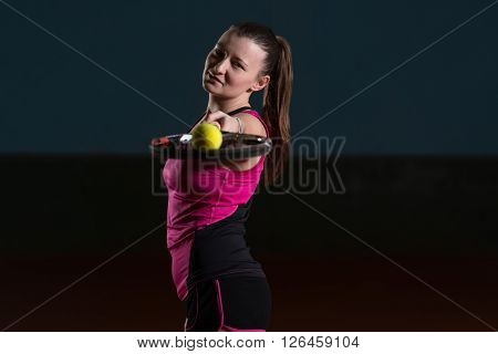 Female Tennis Player With A Racket Indoors