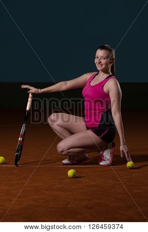 Female Tennis Player With A Racket Indoors