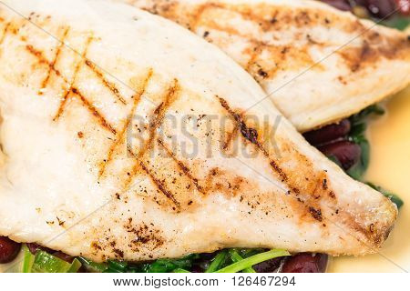 Delicious baked dorado fillet with chard and beans. Macro. Phoro can be used as a whole background.