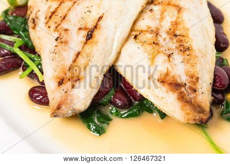 Delicious baked dorado fillet with chard and beans. Macro. Phoro can be used as a whole background.