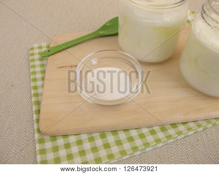 Natural yogurt in jars with inulin powder