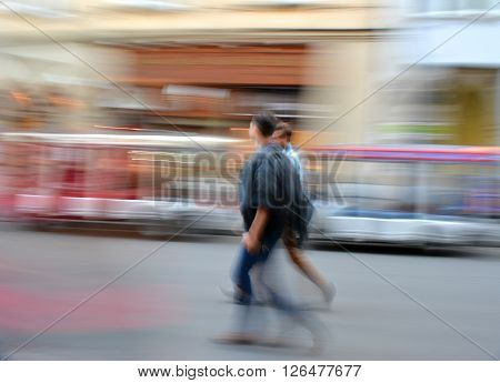 Busy city people going along the street. Intentional motion blur