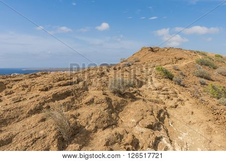 A narrow path runs along the old Ursine of the hill surrounding the Caldera of an ancient volcano on the island of Tenerife.