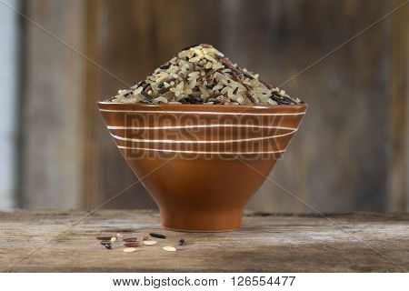 Long grain and wild rice mix in brown bowl