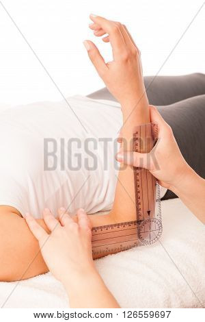 Physiotherapy -therapist Excercising With Patient Using Gonometer To Check The Joint Mobility Of Elb