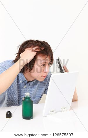 young Japanese man worries about losing hair
