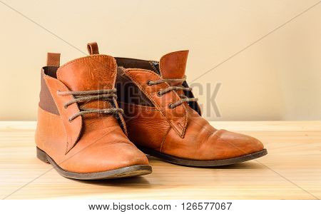 Still life with Brown leather shoes with wooden shoe stretchers on wooden table with clipping path