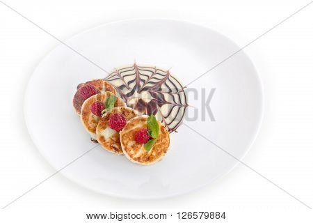 Cheesecakes, curd with raspberries, mint, chocolate and condensed milk isolated sauce