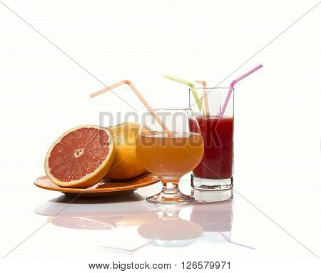 Grapefruits and grapefruit juice on a white gackground