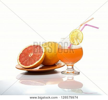 Grapefruits and grapefruit juice on a white gackground