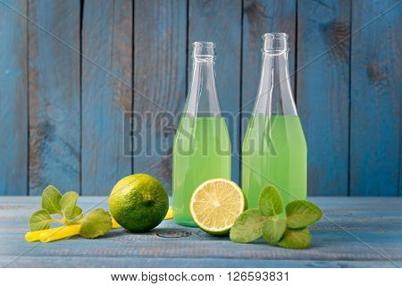 homemade lemonade with lime mint in a mason jar on a wooden rustic table