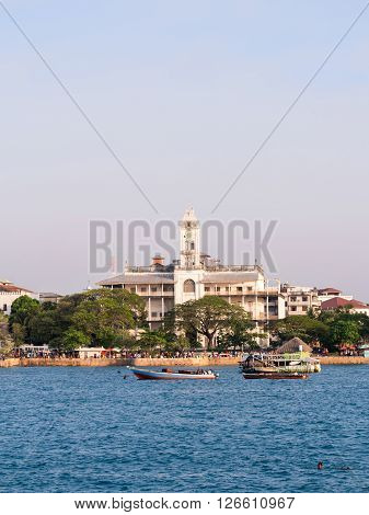 STONE TOWN ZANZIBAR - MARCH 29 2016: Stone Town on Zanzibar with House of Wonders seen from the ferry from Dar es Salaam.