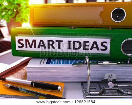 Green Ring Binder with Inscription Smart Ideas on Background of Working Table with Office Supplies and Laptop. Smart Ideas Business Concept on Blurred Background. 3D Render.