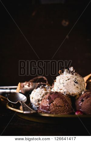 Ice cream with stracciatella and chocolate flavor in the plateselective focus and blank space