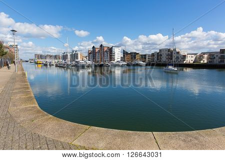 Portishead near Bristol Somerset England UK with blue sky on a spring day and boats moored at quayside and apartments
