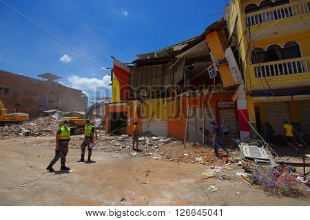 Portoviejo, Ecuador - April, 18, 2016: People gathering their belongings from building showing the aftereffect of 7.8 earthquake that destroyed the city center, and most of the Manabi province.