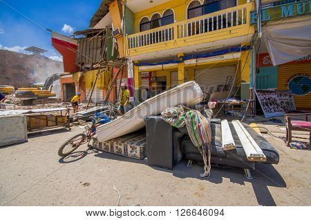 Portoviejo, Ecuador - April, 18, 2016: People gathering their belongings from building showing the aftereffect of 7.8 earthquake that destroyed the city center, and most of the Manabi province.