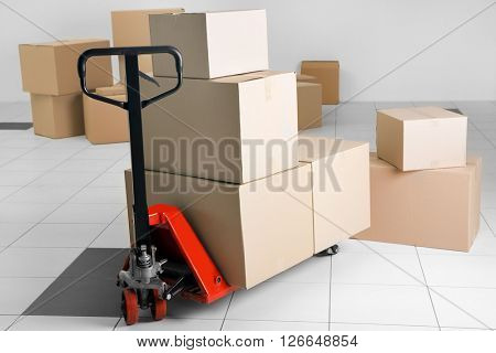 Manual pallet truck with carton boxes indoors