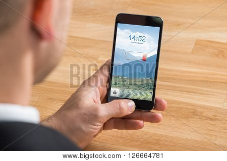 Businessman Holding Mobile Phone With Low Battery