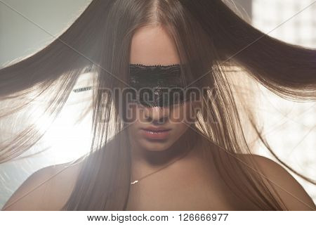 Gentle teenage girl showing her healthy long straight hair. Beautiful Caucasian female model with perfect glossy hair posing in studio.