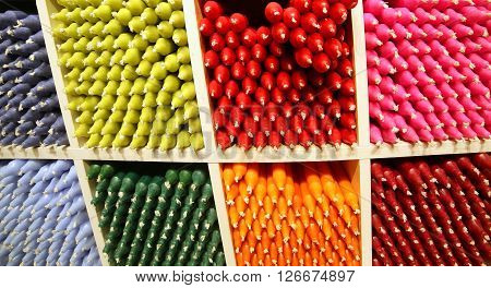 many colored candles on sale in the gift shop