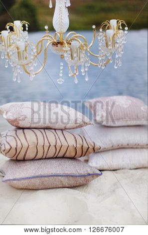 Still life details Cozy interior details soft and warm home decor. Colorful pillows on a sofa with little vase