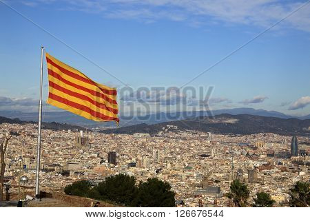 BARCELONA CATALONIA SPAIN - DECEMBER 14 2011: Catalan flag fluttering in the wind in Montjuic Castle