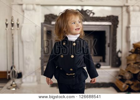 Girl as a chimney sweep against fireplace. Lucky New Year's Eve and New Year.