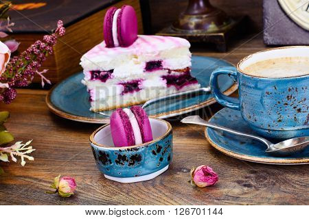 Sweet and Colourful Cake with French Macaroons with Cup of Cofee. Studio Photo