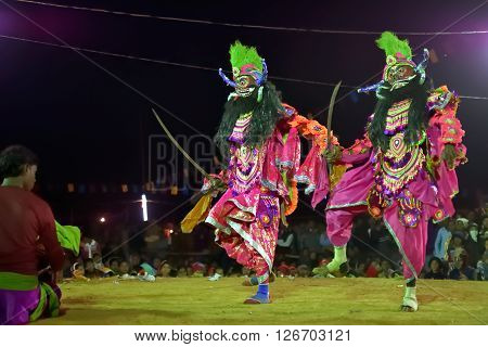 BAMNIA PURULIA WEST BENGAL INDIA - DECEMBER 23RD 2015 : Dancers performing at Chhau Dance festival resurrecting a demon. It is a Indian tribal martial dance based on Hindu myth.
