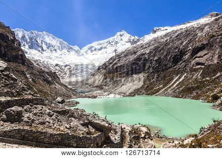 Llaca lagoon (4474 m) in the peruvian Andes and Ocshapalpa peak (5888 m) and Ranrapalca peak (6162 m) Peru
