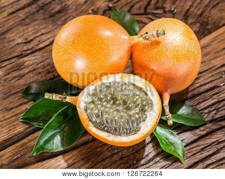 Granadilla fruits on the wooden table.