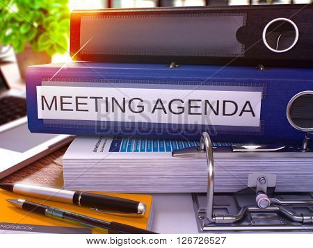 Meeting Agenda - Blue Ring Binder on Office Desktop with Office Supplies and Modern Laptop. Meeting Agenda Business Concept on Blurred Background. Meeting Agenda - Toned Illustration. 3D Render.