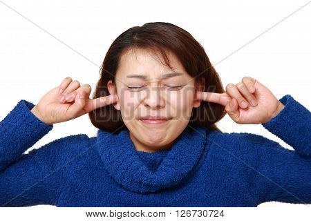studio shot of Asian woman suffers from noise on white background