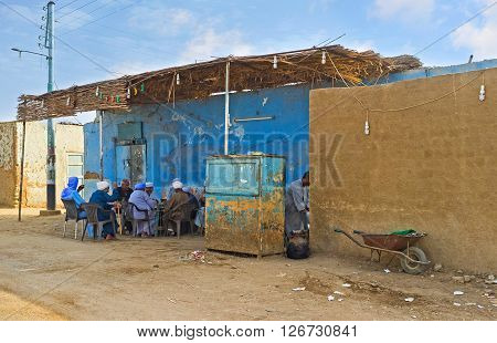 NAJ' AT TUNAB EGYPT - OCTOBER 6 2014: The company of elderly men sits in the shady terrace of the village teahouse on October 6 in Naj' At Tunab.