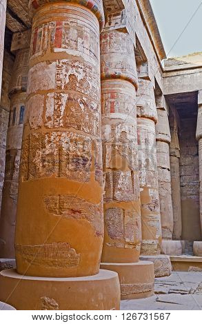 The ancient columns of the Peristyle Court of the Khonsu Temple covered with covered with the reliefs and remains of murals Karnak Complex Luxor Egypt.