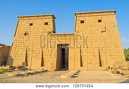 LUXOR EGYPT - OCTOBER 7 2014: The facade of Khonsu Temple decorated with the sacred cobras relief over the entrance gate Karnak Complex  on October 7 in Luxor.
